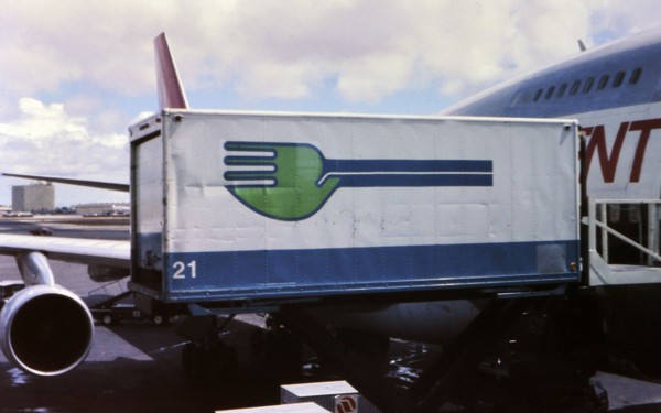 Skychef crew loading a Northwest Orient Airlines plane circa 1976.