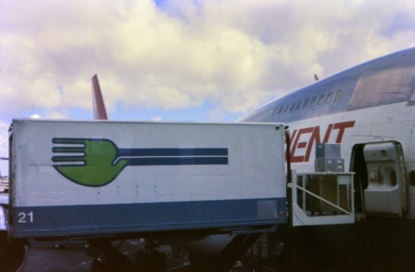 Skychef crew loading a Northwest Orient Airlines plane circa 1976.