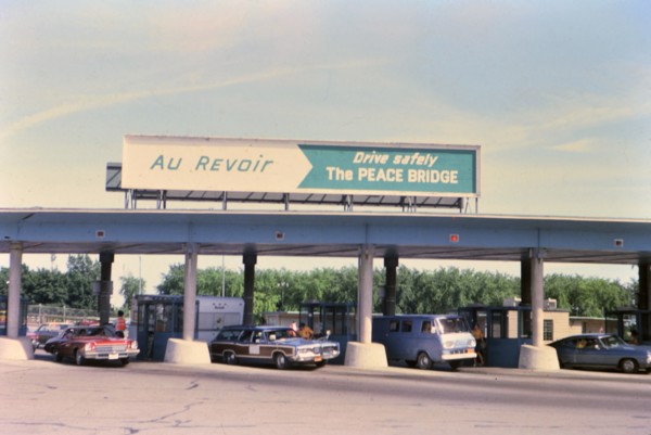 (R) New York 1975 - U.S. Canada border crossing - cars leaving the country circa 1975.