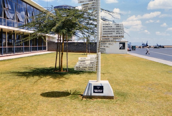 1961 Africa - International distance signs at an airport in Nairobi Kenya (Possibly Wilson Airport).