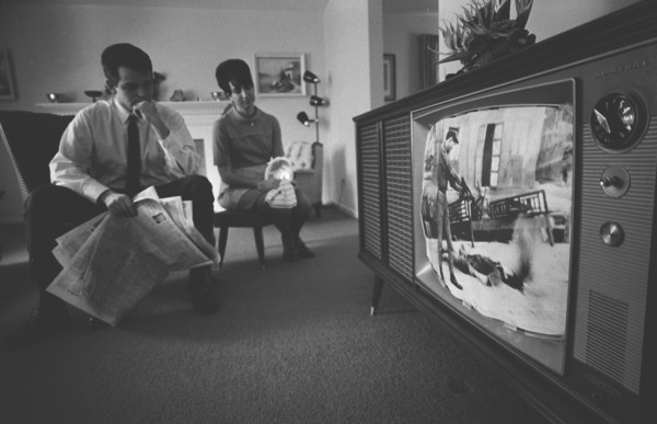 Man and Woman watching Vietnam War TV