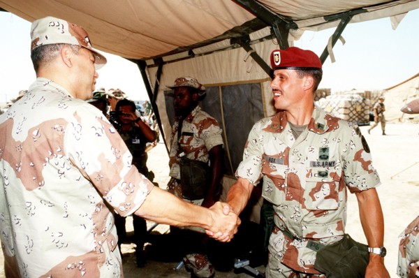 DESERT SHIELD - Colin Powell in fatigues in Saudi Arabia greets Major Fox.