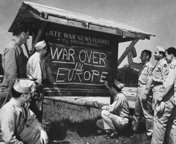 An Army private is shown breaking the news of the end of the war in Europe