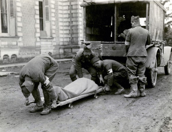 Moving a wounded man from an ambulance
