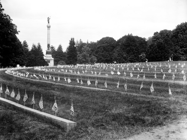 American flags on graves at cemetery