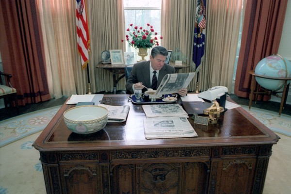 President Reagan eating lunch at his desk in the oval office