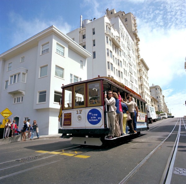 Tourists riding the famous San Francisco cable car