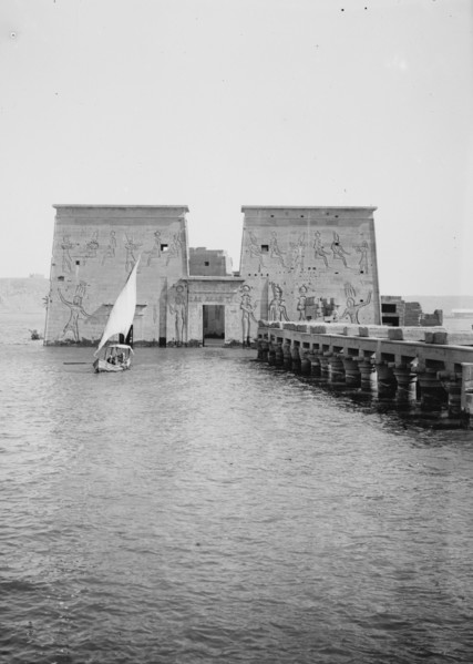 View of 1st pylon of Temple of Isis, Philae, looking North, sailboat in image ca. 1900