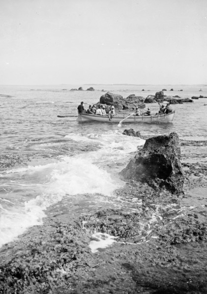 Men in a boat passing the rocks near Jaffa/Joppa ca. 1900