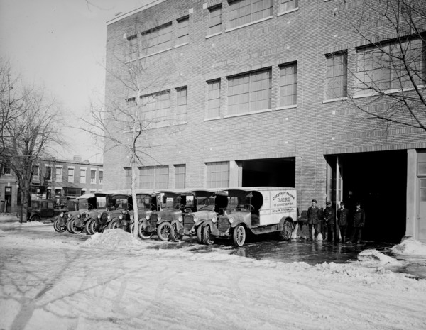 Parked Chestnut Farm Dairy trucks ca.  between 1910 and 1925
