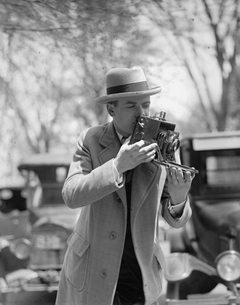 Unidentified photographer with camera ca. between 1909 and 1923
