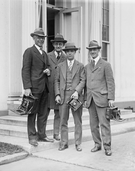 Photographers with cameras on steps ca. between 1909 and 1923