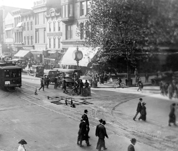 Street scene showing people, a streetcar, automobiles and buildings at the corner of a Washington, D.C. street. ca. [between 1909 and 1920]