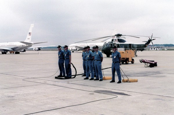 An aircraft maintenance crew stands by as President Jimmy Carter returns from his European visit.