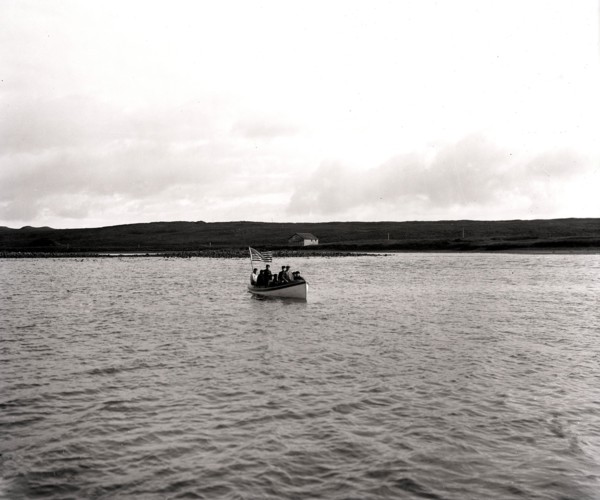 Men in Boat in Village Cove