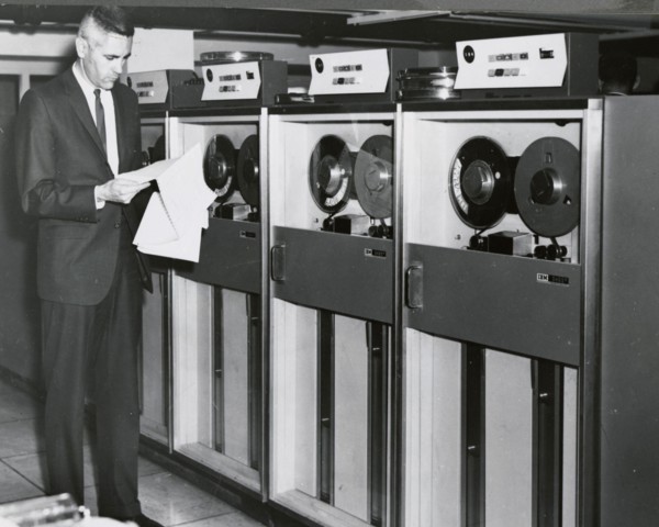Edward Stone in front of an IBM Computer