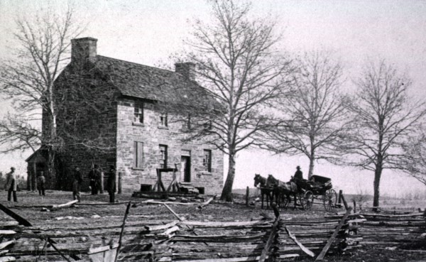 Several men stand outside of Mathew's house