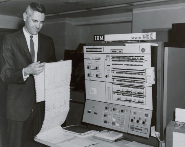 Worker reading printout sheet July 1967 in front of IBM 360