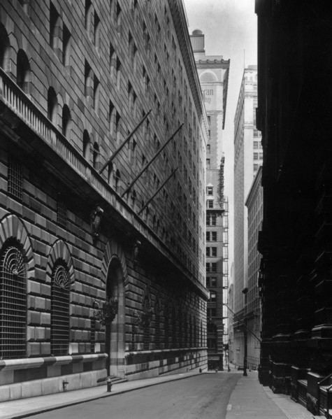 1930s New York City - Massive facade of Federal Reserve building fills left side, looking down Maiden Lane ca. 1936