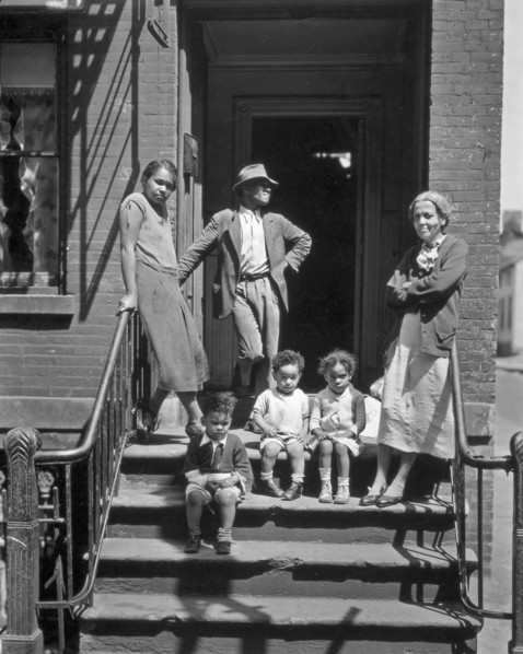 Three generations of African Americans on stoop of brick home with iron rails on steps. Jay Street, No. 115, Brooklyn ca. 1936