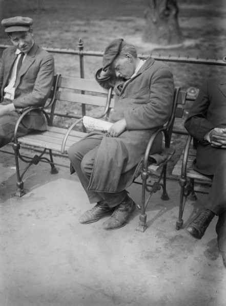 Man sleeping on a park bench in Union Square ca. 1910-1915