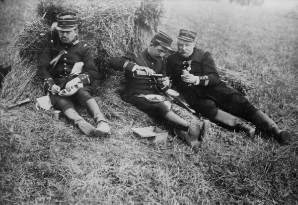 French soldiers eating and drinking wine in a field probably during World War I ca. 1914-1915
