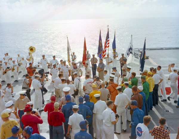 (21 July 1966) The crew of the Gemini-10 spaceflight, astronaut John W. Young (left), command pilot, and Michael Collins, pilot, talk on live radio and television during welcome aboard ceremonies on t...