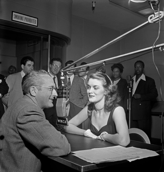 Tommy Dorsey (left) interviews the English pigeon, Beryl Davis, for his first disc jockey stint, with such names as Georgie Auld, Ray McKinley, Mary Lou Williams, Josh White and others visible in the ...