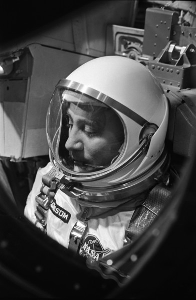 (23 March 1965) Astronaut Virgil I. Grissom, the command pilot of the Gemini-Titan 3 mission, is shown through the window of the open hatch on the Gemini spacecraft in the white room on the morning of...