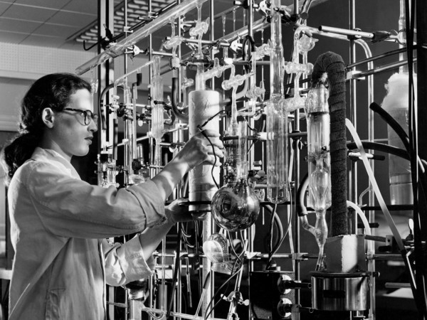 A materials researcher at the NACA’s Lewis Flight Propulsion Laboratory examines a surface crack detection apparatus in the Materials and Stresses Building during December 1952.