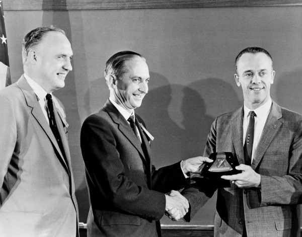 (1 Oct. 1961) Astronaut Alan B. Shepard Jr. (right) receives a plaque and award from members of the British Rocket Society.