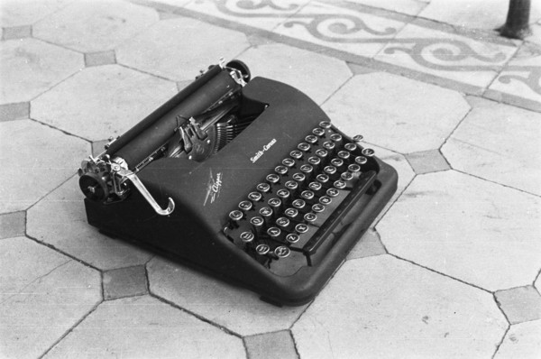 A typewriter on a tile floor; Brand Smith Corona; Date May 1947 Location Indonesia, Dutch East Indies