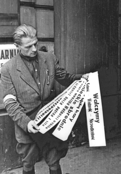 Warsaw Uprising: Insurgent posters presented by Roman Rozmilowski "Zawada", from "Koszta" Company, in front of print-shop "Stoleczna" at Moniuszki 11 Street ca. August 1944