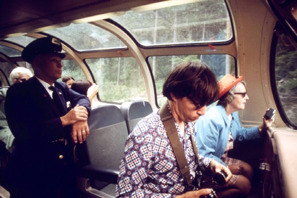 Camera enthusiasts enjoy the observation car aboard Expo '74 as the passenger train passes through the Cascade Mountain Range enroute from Spokane to Seattle, Washington, June 1974