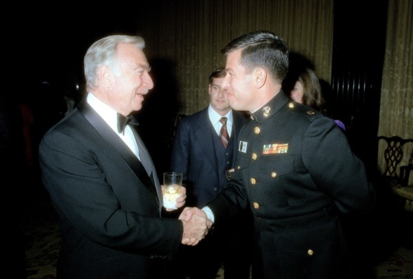 A Marine Corps major shakes hands with Walter Cronkite