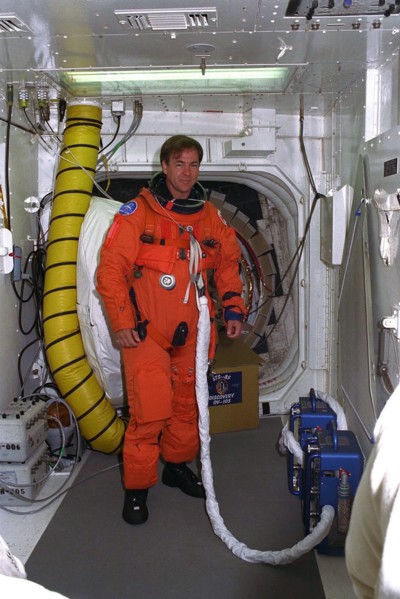 STS-85 Payload Specialist Bjarni V. Tryggvason poses in the white room at Launch Pad 39A with his ascent/reentry flight suit ca. 1997