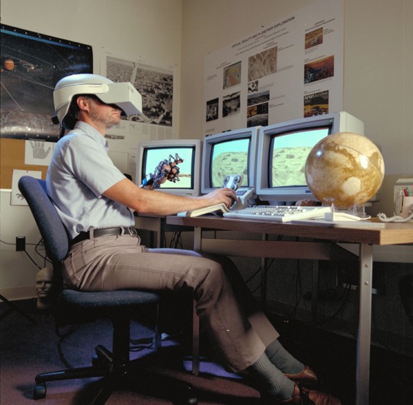 1992 - Virtual Environment Telepresence workstation, simulated Mars Exploration shows Lewis Hitchner with virtual helmet and EXOS Dexterous interface (virtual hand)