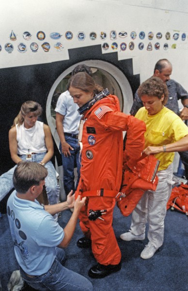 STS-40 MS Jernigan dons LES parachute pack prior to egress training at JSC