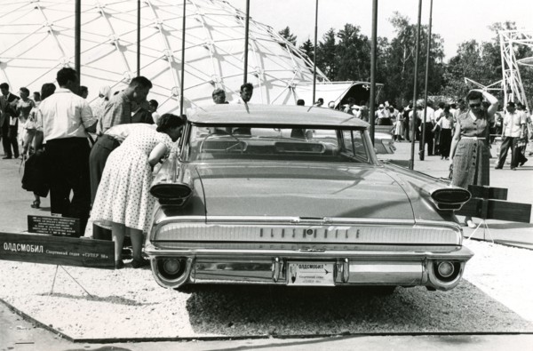 Interested spectators look inside an Oldsmobile, 1959