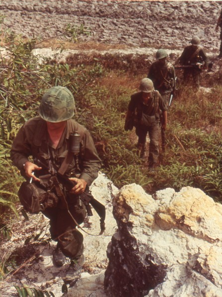 American patrol searches for Viet Cong in a rocky area near Saigon. Vietnam, 1967.