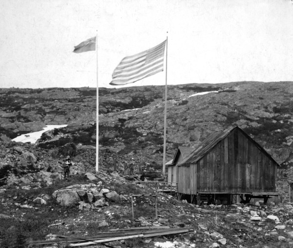Alaska-Canada border with American and Canadian flags