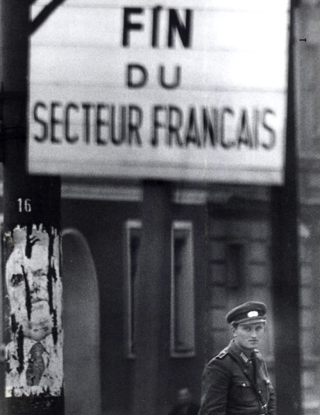 Officer Of East German Peoples Police Stands Guard At Control Point At Brunnenstarsse, A Workers