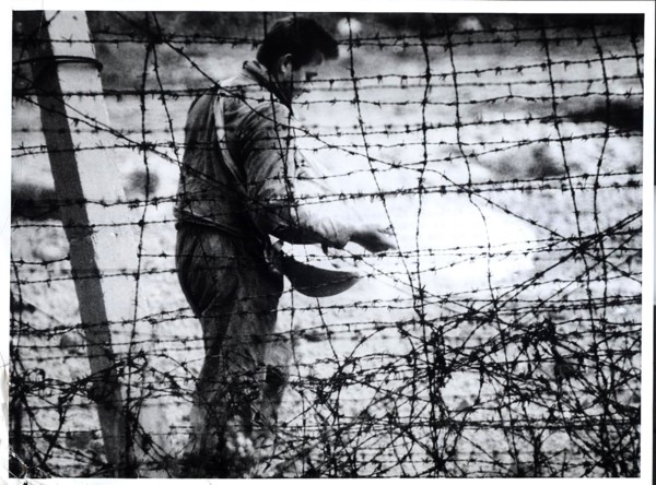 'Death Strip' Although He Resembles A Farmer Sowing Seed, This East German Workman Is Sprinkling