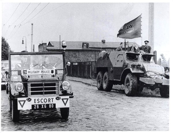 The Dividing Line Actually Runs Between The Two Vehicles. In the Right Background Is Part of the