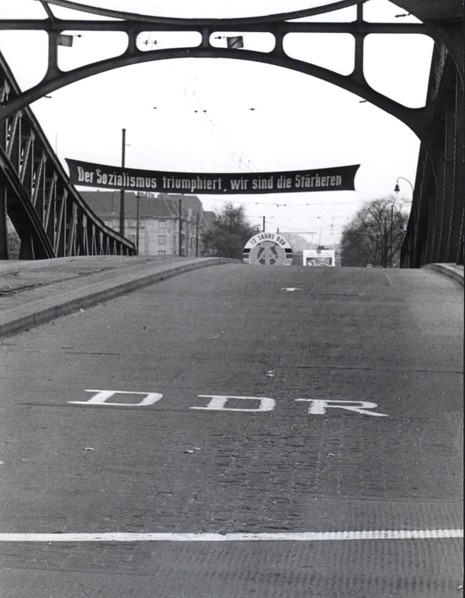 The Banner Exclaims 'Socialism Will Prevail We Are Stronger' Under It the Letters 'DDR' Directly