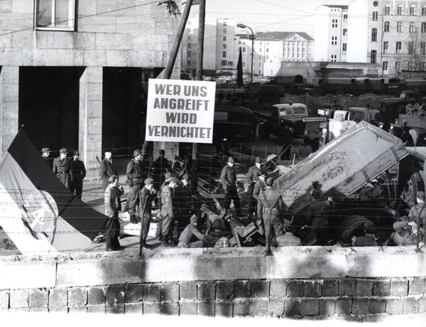 Banner Says 'Whoever Attacks Us Will Be Destroyed'. Example of an East German Confrontational