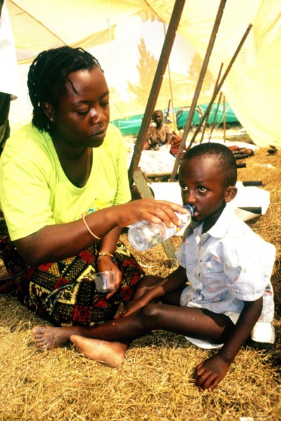 1994 - A mother gives her child water at the Kitali refugee camp in Goma, Zaire.
