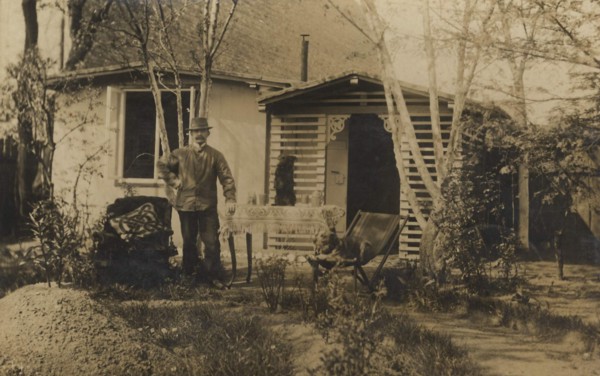 Man In A Hat In The Garden In Front Of His House