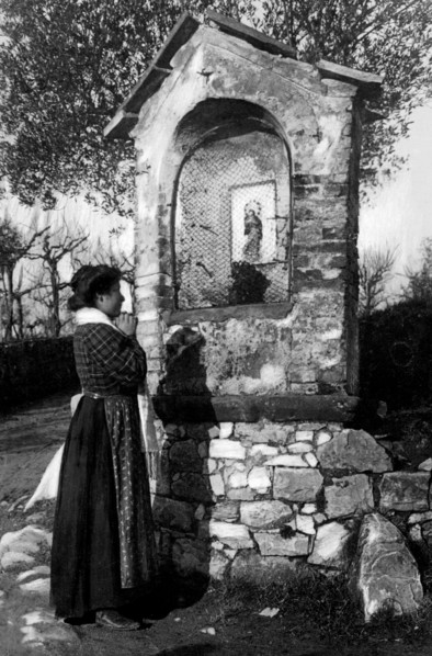 italy, woman praying at chapel, 1910