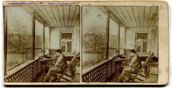 A stereo, a man with a boy playing checkers on the porch at home.